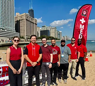 Faculty and fellows at the 2026 Big Shoulders swimming competition in Chicago, Illinois. Lake Michigan is in the background.