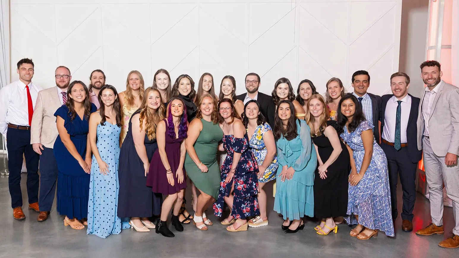 pediatrics residents in formal wear pose together for a large group photo at graduation