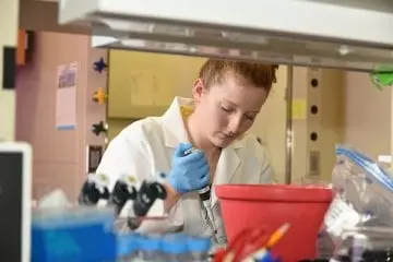 Dr. Shannon Hawkins in lab with pipette
