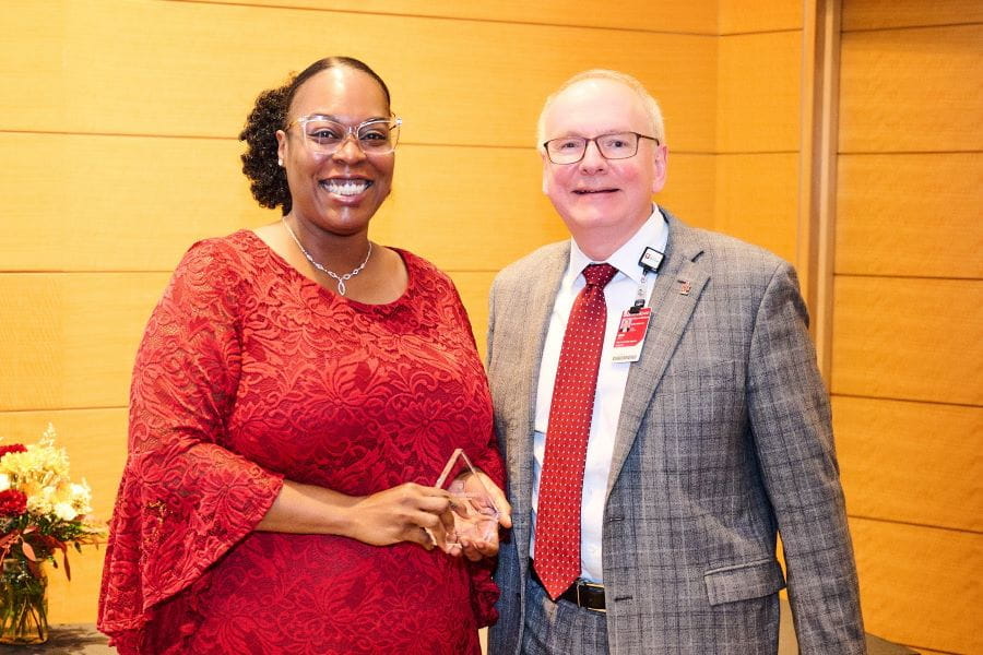 Dawn Wright receives an award from Dean Hess at the fall 2023 all school meeting