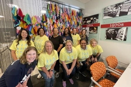 a group of staff in matching t shirts at a volunteer event
