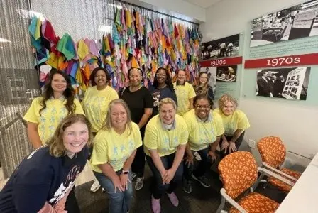 a group of staff in matching t shirts at a volunteer event