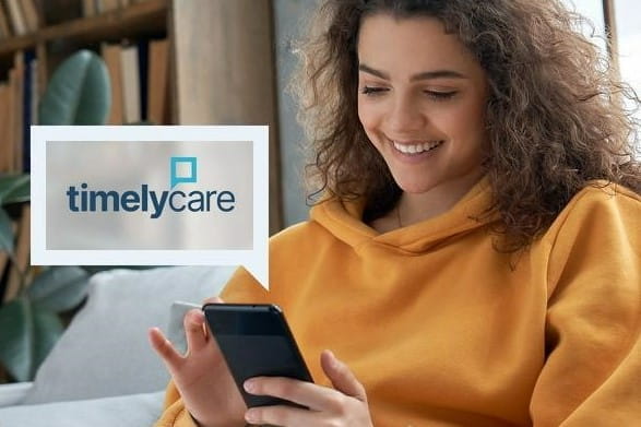 a woman looks at a resource on her cell phone