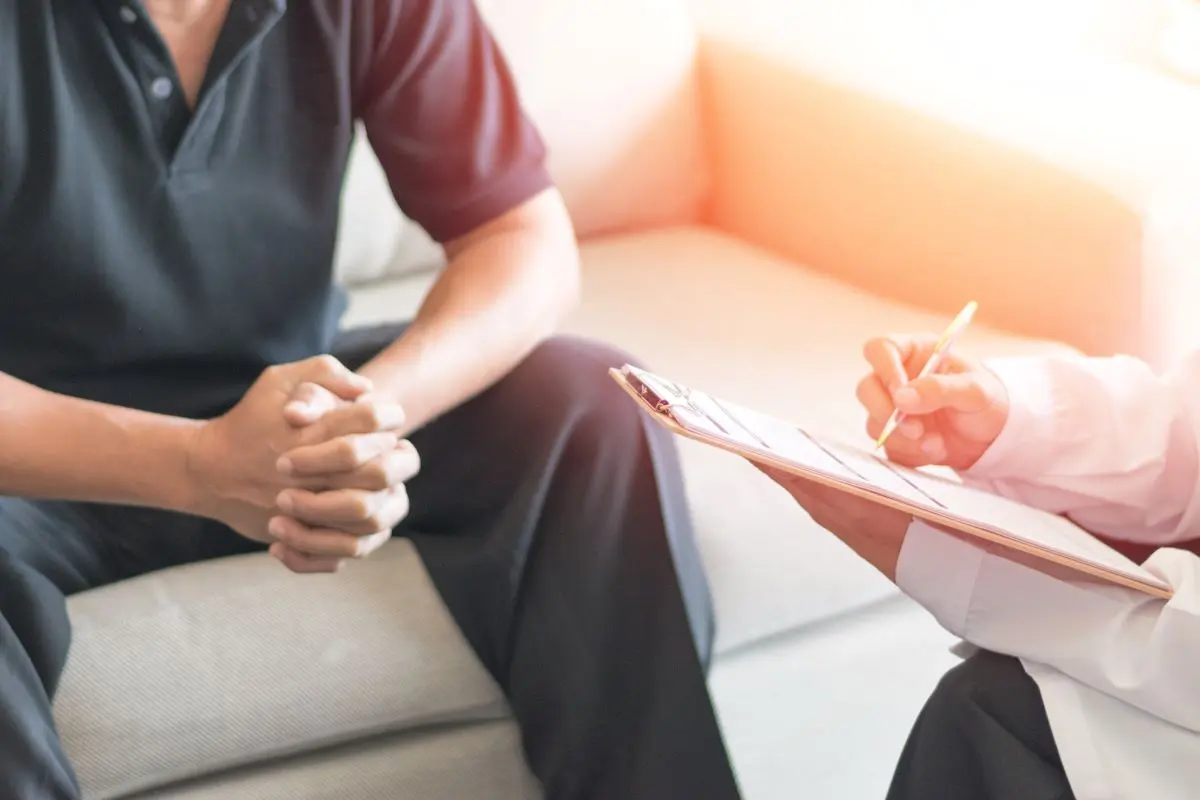 physician consulting with male patient in an exam room