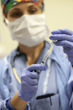 physician in scrubs in OR