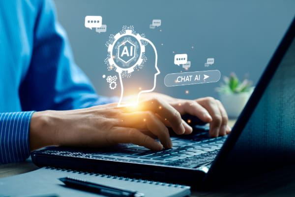 Person typing on laptop with images representing artificial intelligence emerging from the computer screen