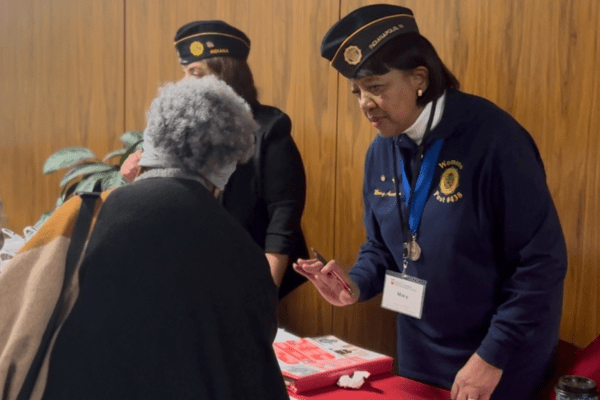 Mary Aurtrey speaks to an attendee of the annual Martin Family Caregiver Symposium at the IU Neuroscience Center