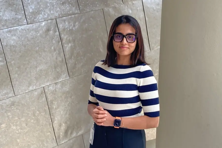 Bhavana Sivakumar stands with her hands together. 