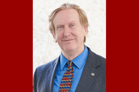 Headshot of Richard Gunderman on a red background.