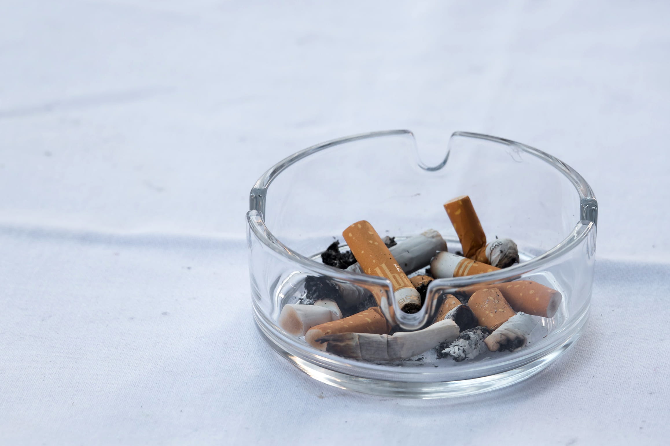 A photo of cigarette butts in an ashtray.