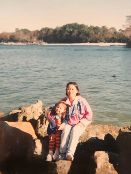 Angel Jones as a child with her mother in front of a lake