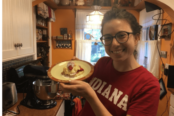Abigail Brenner holding up a plate of strawberry shortcake