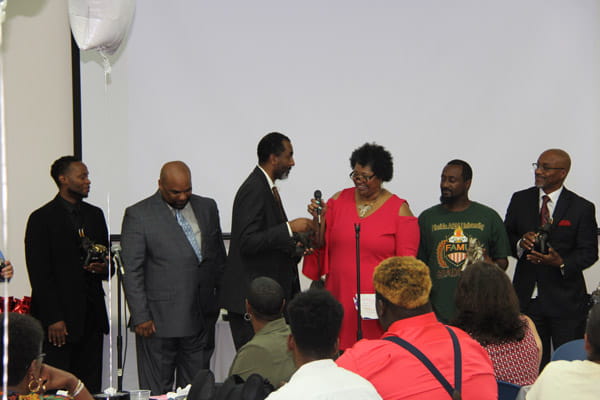 Clark Simons MD accepts an award at a community event