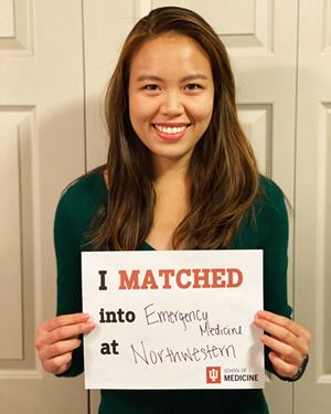 evelyn huang holds a sign with her match on match day