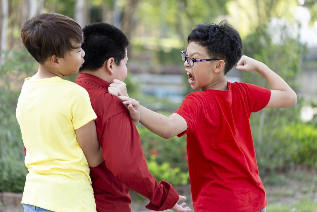 three boys fighting