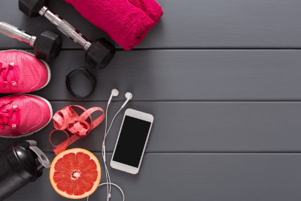 iphone, running shoes, half a grapefruit, ear buds, weights and workout towel