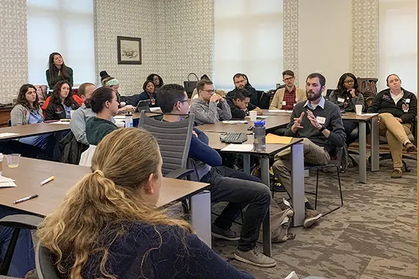 Residents listen to a speaker during the global health residency track.