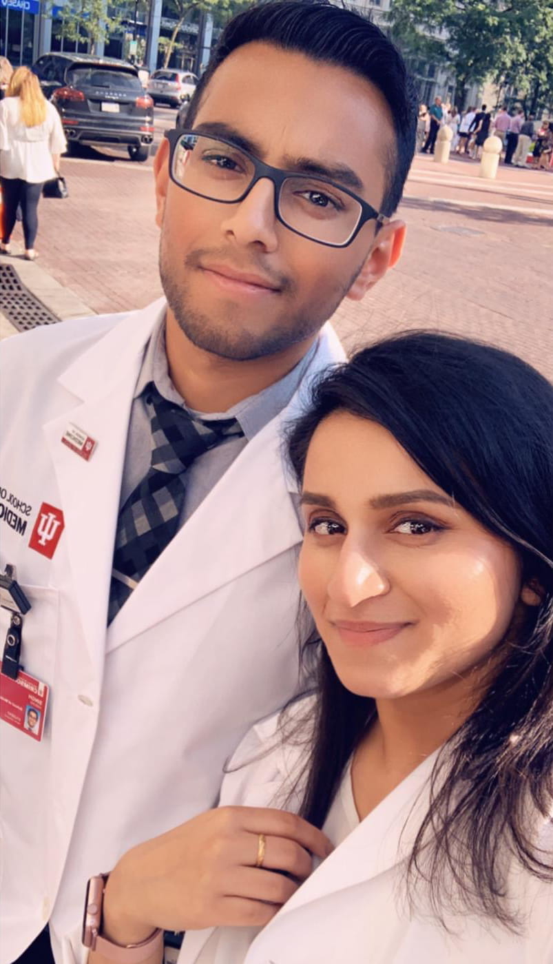 Harjas Singh and Harleen Kaur in white coats
