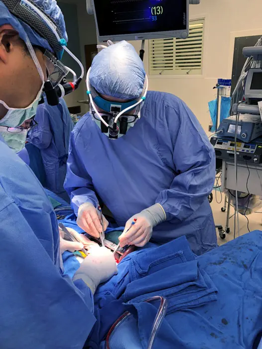 Kevin Graham performs surgery with colleagues