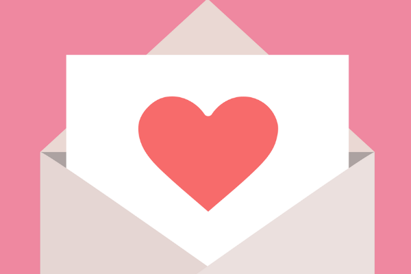 letter with red heart on pink background