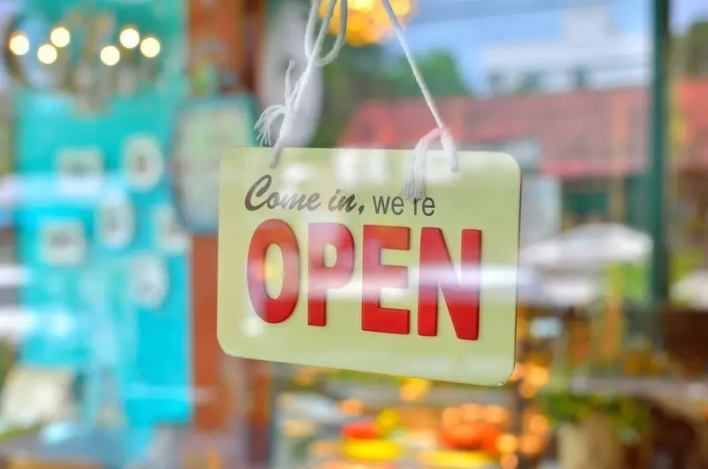 Come in, we are open sign haning in a glass door