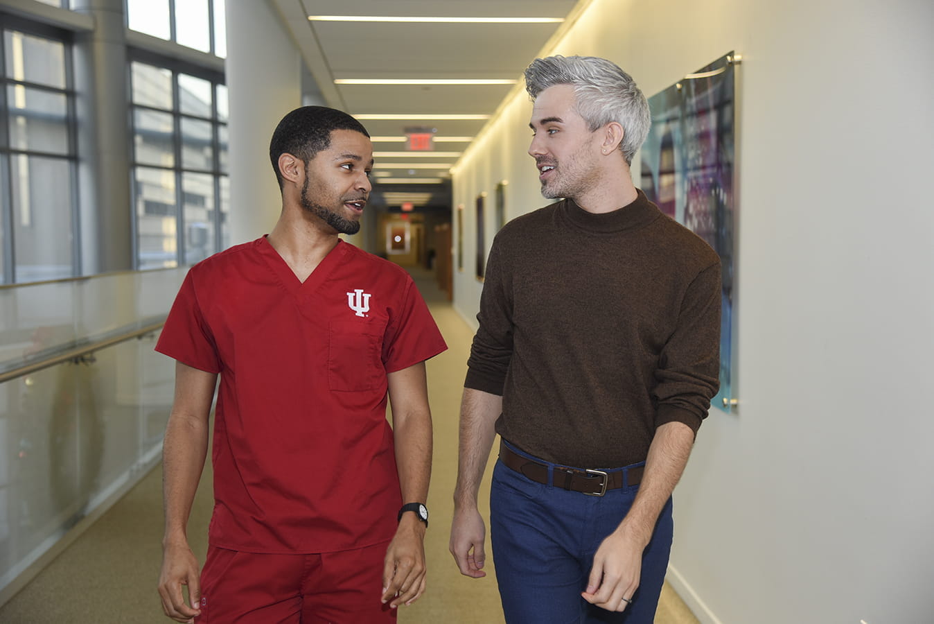 Psychiatry resident, Dustin Nowaskie, MD and IU nursing student, Jared Riley, walking in Goodman Hall.