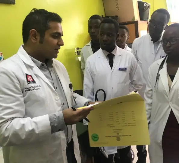Avinash Mantravadi, MD goes over surgeries with medical students and residents at Moi University School of Medicine.