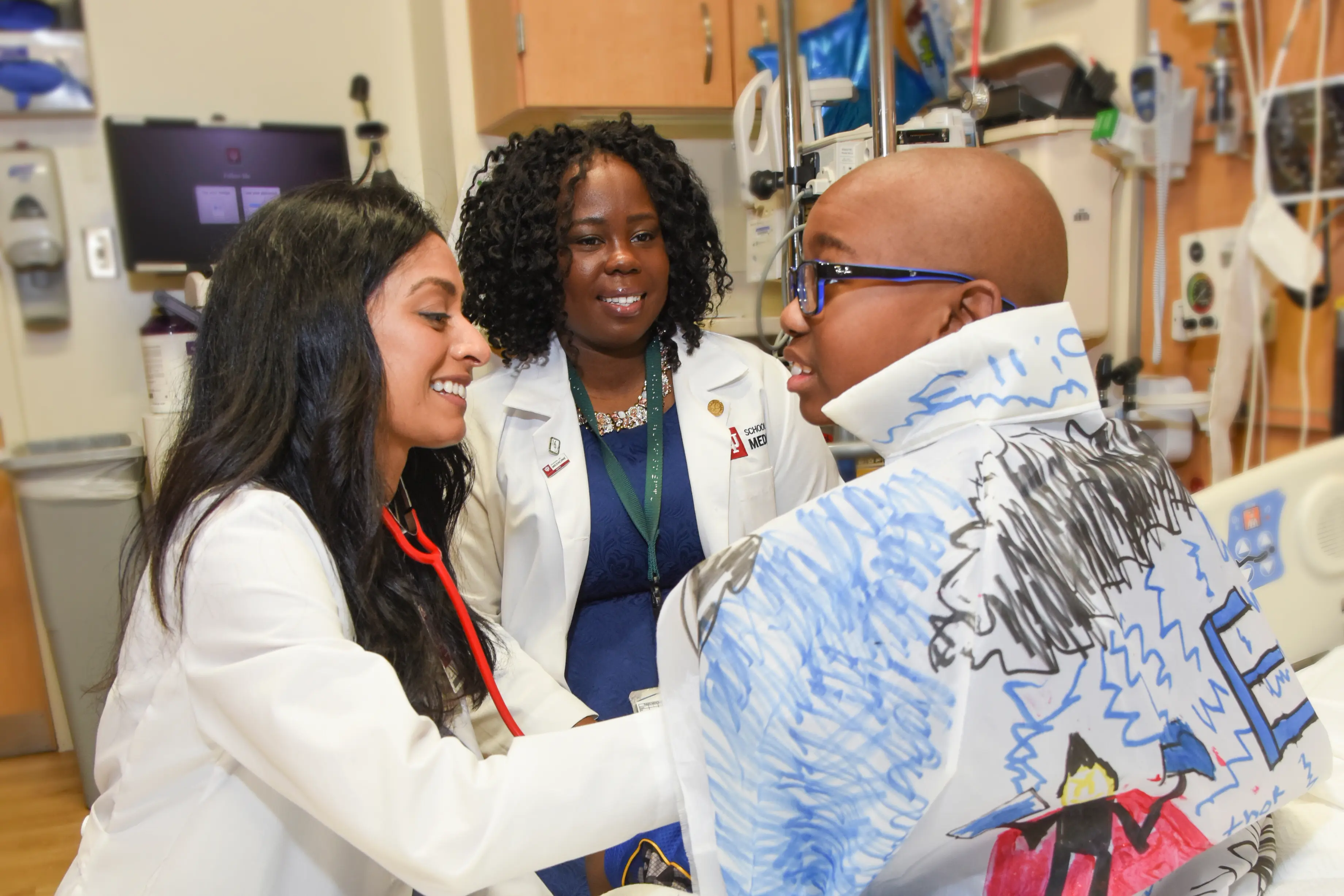 Seethal Jacob, MD, with a sickle cell patient at Riley