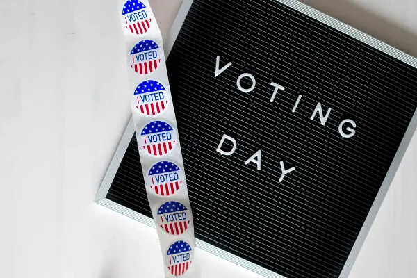 Sign that says Voting Day with "I voted" stickers