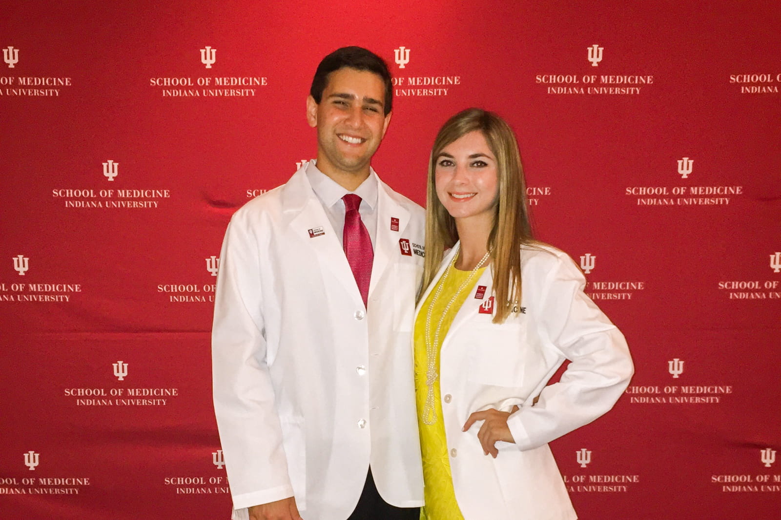 Carlos Martinez and Sarina Masso in white coats