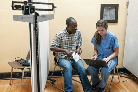 a student talks with a patient at the student outreach clinic in indianapolis