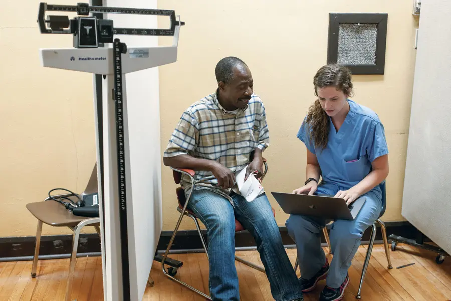 a student talks with a patient at the student outreach clinic in indianapolis