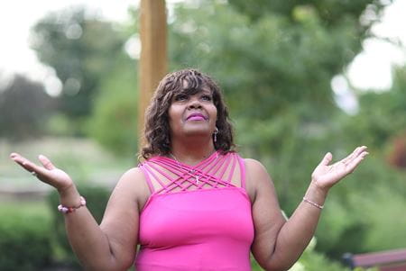 image of woman with uplifted hands