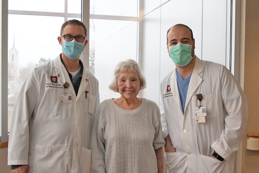 Faith Fouch takes a photo with her physicians the day after her TAVR surgery