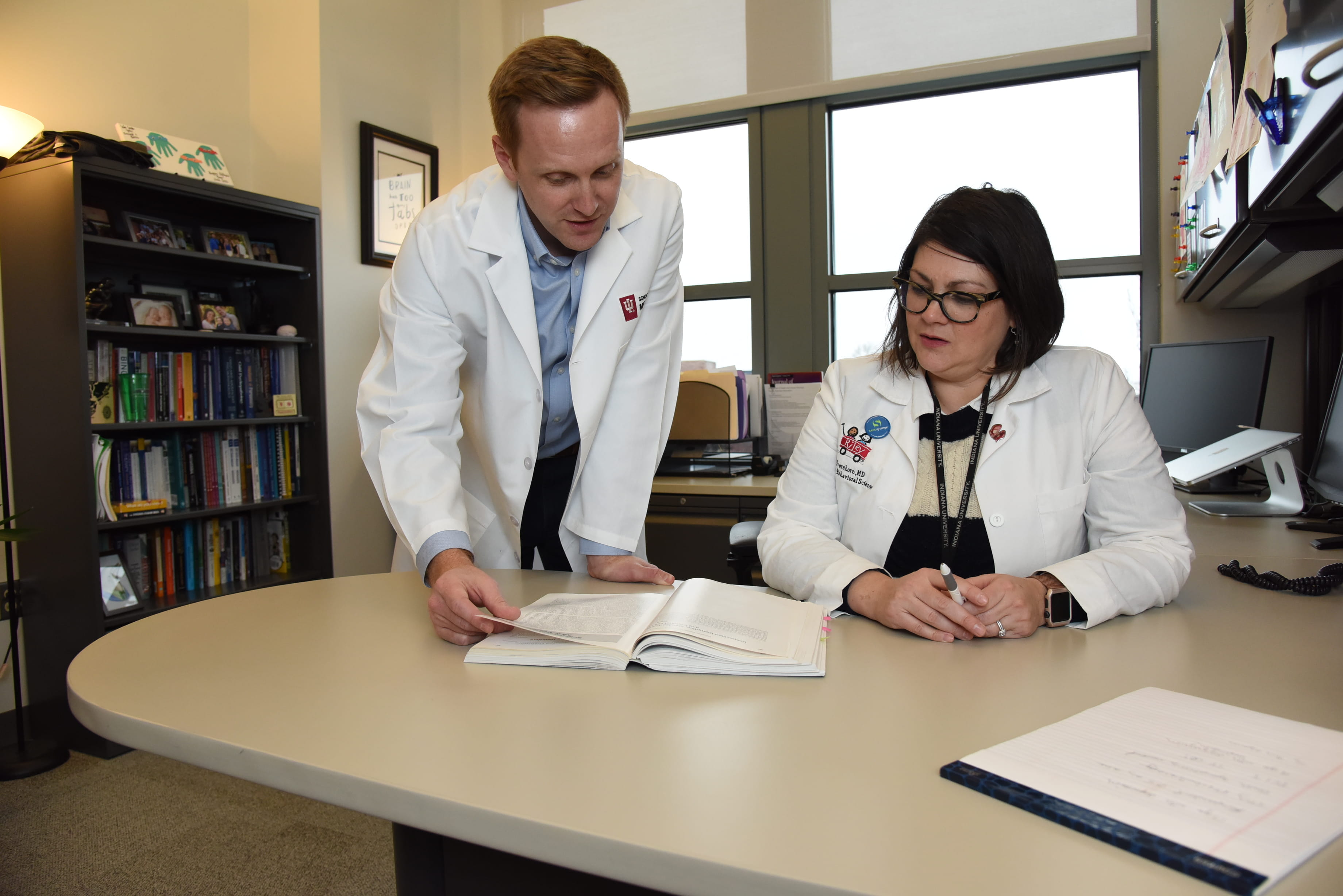 Drs. Zachary Adams and Leslie Hulvershorn review paperwork