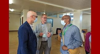 Three men having a conversation