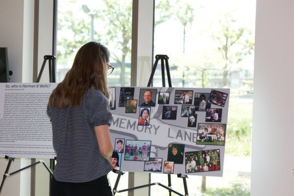 woman viewing a photo collage exhibit