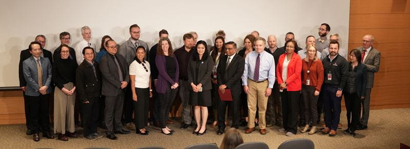 large group photo of faculty on stage