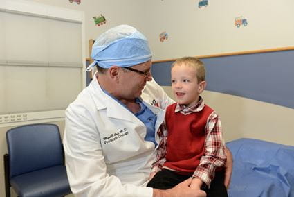 Dr. Mark Cain with a patient at Riley Hospital for Children