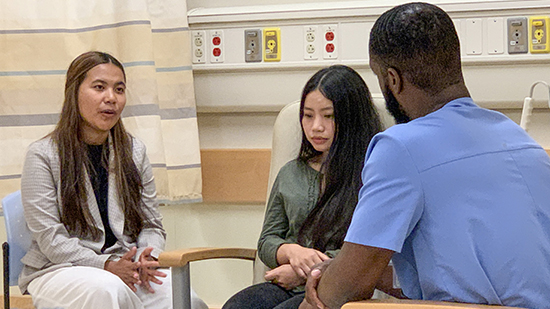 Physician sitting with two young ladies