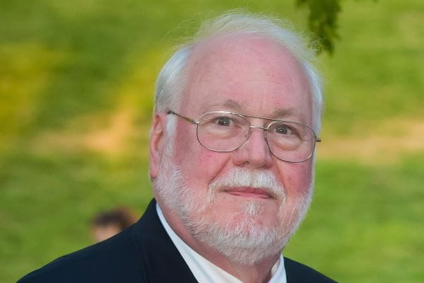 outdoor portrait of John Eble, MD with grass background