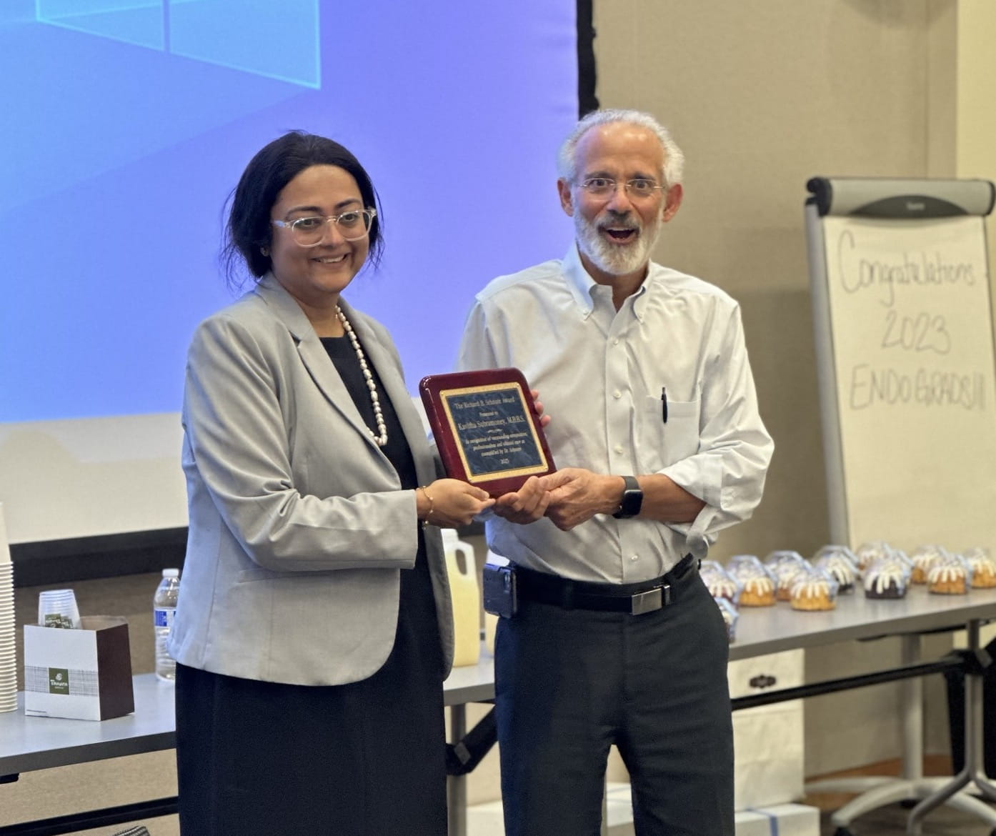 Dr. Subramoney, left, accepts her award.