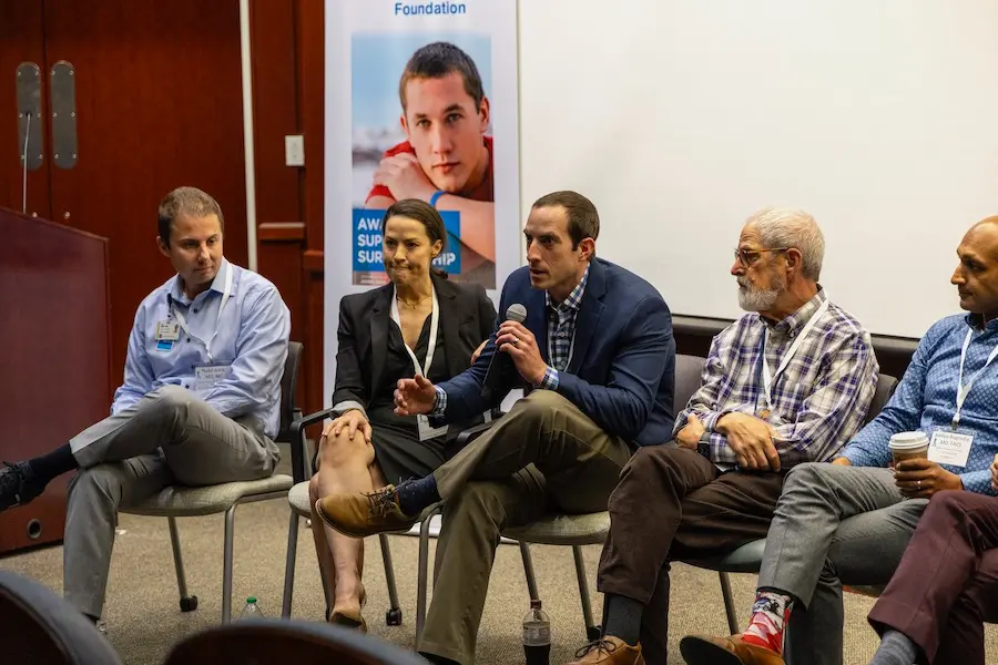 Sean Kern speaking, seated with other testicular cancer experts