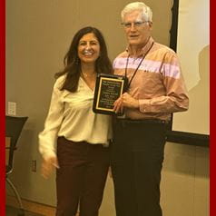 Dr. Walsh, right, accepts his award.
