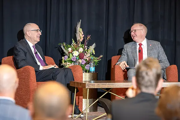 Skorton and Hess share a laugh during the 2024 Stephen P. Bogdewic Lectureship in Medical Leadership event Oct. 14 at IU Indianapolis.