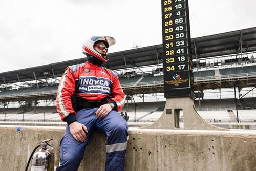 Leonard Edwards in his IndyCar Medical Team fire suit, sitting on the Pit Row wall at the Indianapolis Motor Speedway