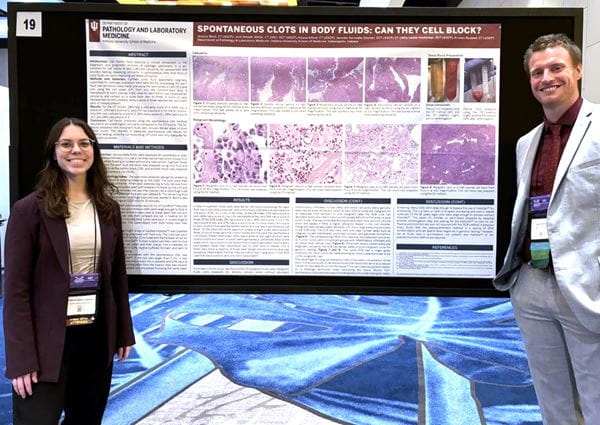 Jessica Rech and Josh Howell in front of their poster