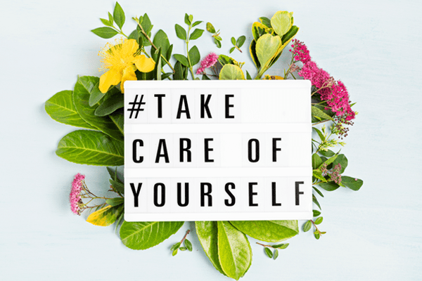 Lightbox surrounded by flowers with motivation words "Take care of yourself"