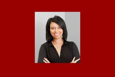 Portrait of Tamika Dawson-Knox in black top against grey background