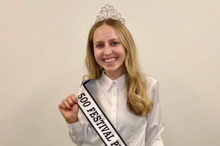 Elizabeth Baker in white shirt wearing her princess tiara and sash